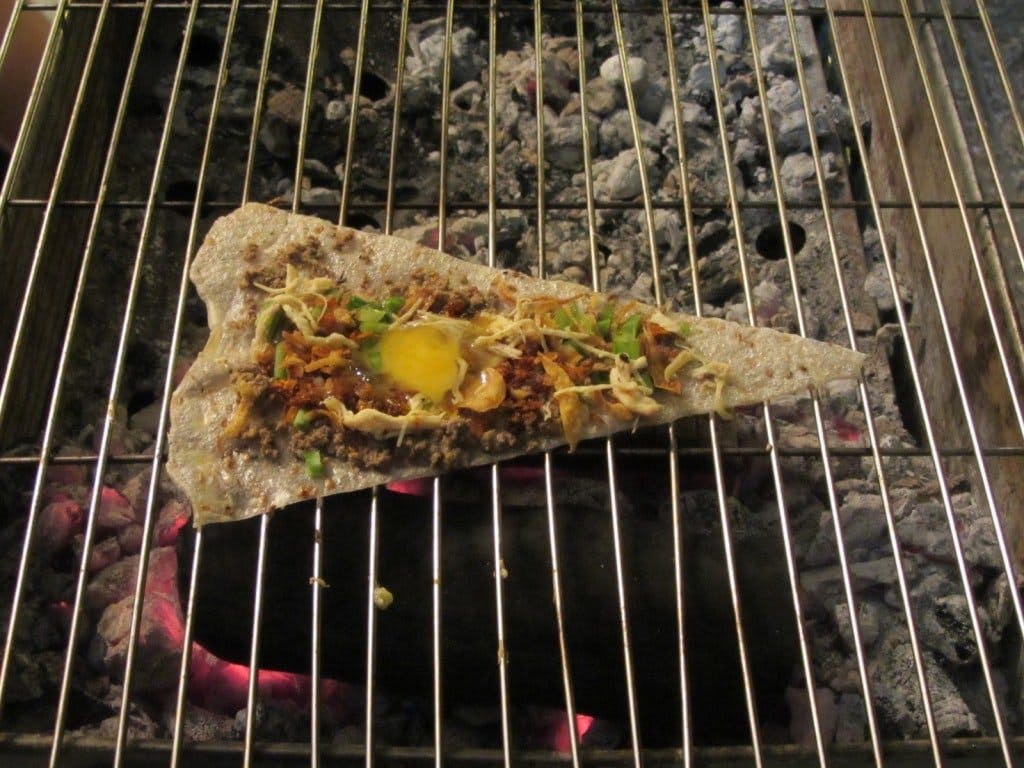 Cooking over the bếp than (charcoal grill)